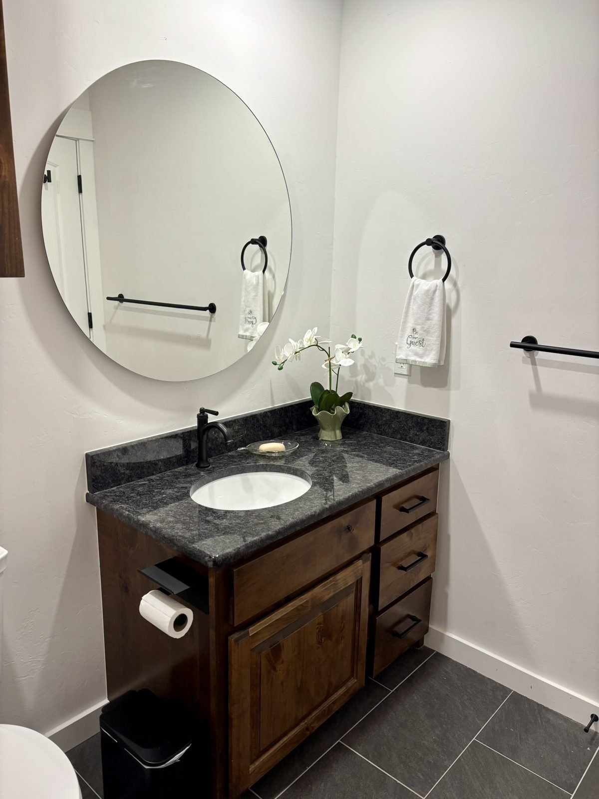 The custom alder vanity and backlit mirror