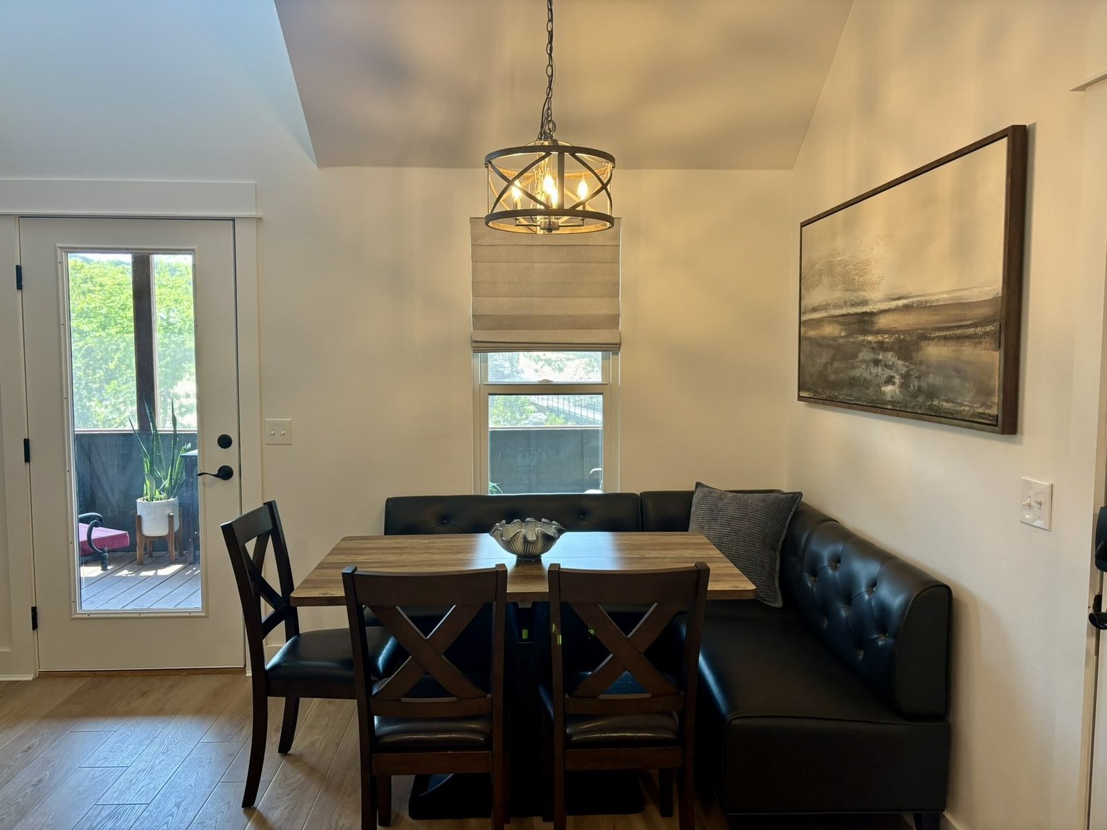 The dining banquette with a wooden table and seating for seven