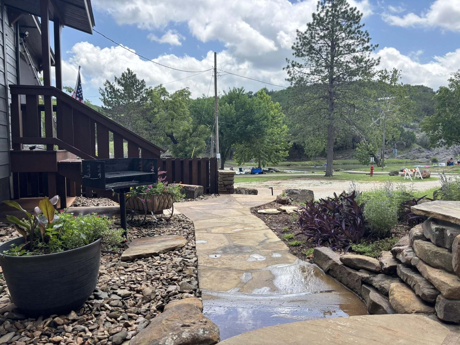The flagstone path leading down from the terrace toward the creek and the park